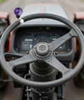 Purple Power Steering Wheel Knob Spinner Turn Aid Grip For Tractors Forklifts And Lawn Mowers on a tractor steering wheel.