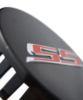 Fresh Set Of Four 68 Millimeter Stainless Steel Wheel Center Caps Featuring Raised Double Slash SS Badges For Chevy Camaro Rim Covers close-up showing stainless steel emblem.