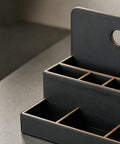 Close-up of a black leather Eight Compartment Desk Organizer And Mail Holder That Keeps Your Desk Clean And No Fuss on a desk.