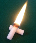 Easy Light Tinder for Camping and Survival with flame, natural wood fiber lit on green surface