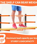 Heavy Duty Wall Mounted Lumber Storage Rack Three Level Four Pack For Garage Storage Holds Wood Pipes And Skis With 300 Lbs Capacity Organizer Bracket Black And Orange Garage Gear showcasing weight capacity with person standing on shelf.