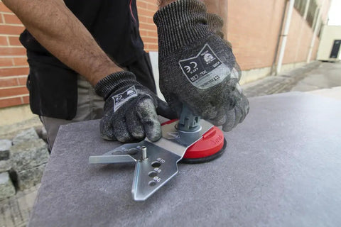 Precision Hole Drilling Guide With Suction Cup for Dry and Wet Cutting on a flat stone surface with gloves in use.