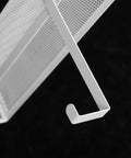 Close-up of the white metal hook from the Super Heavy Duty Over The Door Storage Rack With Two Roomy Mesh Baskets And Eight Sturdy Metal Hooks.