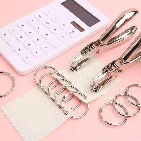 Compact Single Hole Punch Metal Circle Punch for scrapbooking and office use, 6mm hole puncher, portable craft tool on pink background with rings
