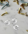 Close-up of 20 Pack Hurricane Shutter Wing Nuts 1/4-20 with Washer Base for quick release on marble surface, surrounded by screws.