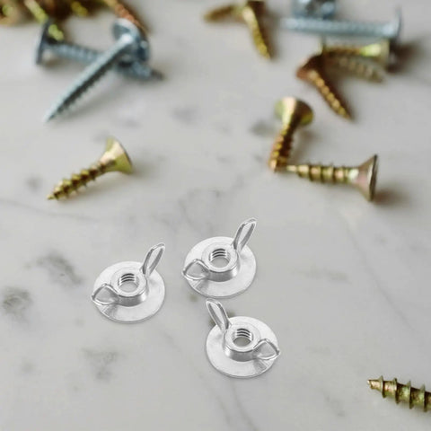 Set Of 20 Metal Thumb Nuts For Hurricane Shutters With Washered Backplates, shown with assorted screws on marble surface