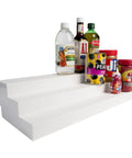 3 Tier Expandable Cabinet Shelf Organizer Knockout Storage Hack Heavy Duty Build with bottles and jars on white design.