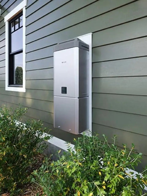 Top Shelf Dual Fuel Condensing Tankless Water Heater Loaded With Smart Sense Controls mounted outdoors on a green wall.