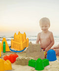 Child building sandcastle using 7 Piece Beach Sand Toys Set With Buckets Shovels Rakes And Castle Sand Molds For Kids Bright And Kid Friendly Beach Accessories