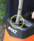 Beast 1800W Electric Wood Chipper Shredder cutting a branch, yard cleanup tool with 21 to 1 reduction and 50-liter bag