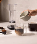 High Performance Flow Control Filter Cap For Manual Coffee Brewers delivers complete brew command while pouring milk into coffee.