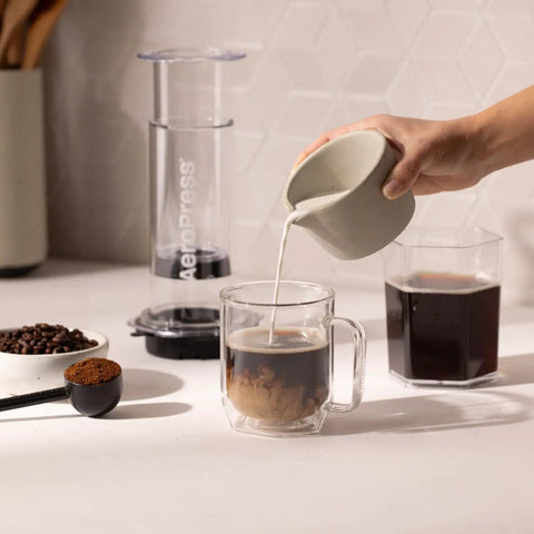 High Performance Flow Control Filter Cap For Manual Coffee Brewers delivers complete brew command while pouring milk into coffee.