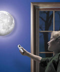 Child using remote to control Moon In My Room Light Up Lunar Phases Kit With Remote Control Or Automatic Mode STEM Toy for kids.