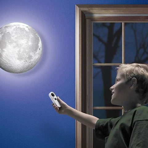 Child using remote to control Moon In My Room Light Up Lunar Phases Kit With Remote Control Or Automatic Mode STEM Toy for kids.