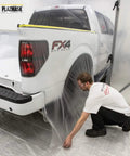 Person applying Pre Taped Masking Film With Three Quarter Inch Tape, Two Feet By Sixty Five Feet, Twelve Pack on truck for protection.