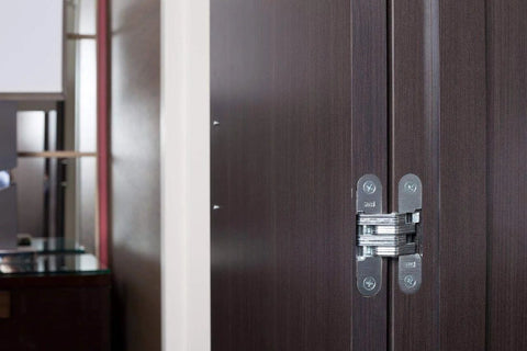 Invisible Satin Brass Concealed Cabinet Hinge Three And Three Quarters Inch With Two Holes Per Leaf One Hundred Eighty Degree Range Of Motion Non Handed Zamac And Steel Construction For Doors And Cabinets Ideal For Frameless And Traditional Styles By SOSS installed on brown cabinet