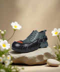 Built Tough Aluminum Safety Toe Overshoes With Grippy Anti Slip Rubber Soles For Rough Industrial Jobsites on a display rock.