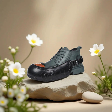 Built Tough Aluminum Safety Toe Overshoes With Grippy Anti Slip Rubber Soles For Rough Industrial Jobsites on a display rock.