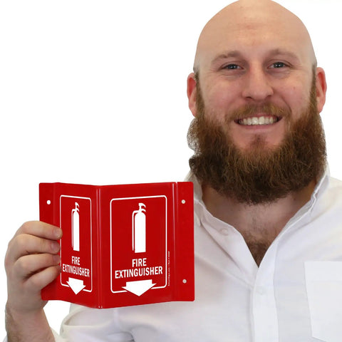 Person holding a Projecting Fire Extinguisher Sign With Down Arrow, Two Sided Wall Mount Corridor V Sign, Polished Acrylic White On Red, 5 By 6 Inches.