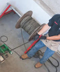 Heavy-Duty UT10-22 Puller for Cable and Wire Pulling in use on job site, worker using pro-grade tool, durable electrical hand tool.