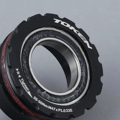 Close-up of Token T47 Threaded Bottom Bracket Black For Shimano 24mm Steel Bearing showing alloy build and bearing detail.