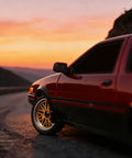 One Eighteen Scale RC Drift Car With Gyro Stabilization In Vintage Red driving on scenic road at sunset