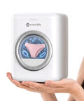 Slim Portable Mini Washer That Crushes Small Loads Without The Hassle A Real Game Changer For Dorm Life And Weekend Trips With Snappy USB C Charge being held with a pink undergarment inside.