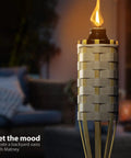 Bamboo Tiki Torches Outdoor Mosquito Repellent 12 Pack, 60 Inch Tall Garden And Backyard Lights illuminated in a backyard setting