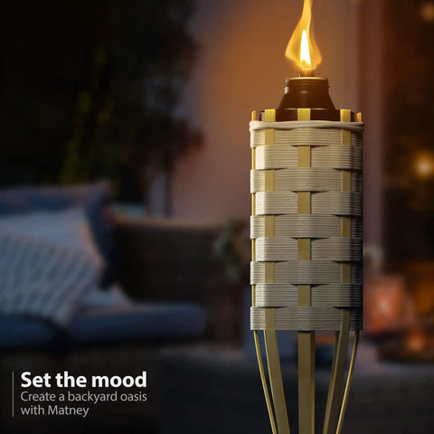 Bamboo Tiki Torches Outdoor Mosquito Repellent 12 Pack, 60 Inch Tall Garden And Backyard Lights illuminated in a backyard setting