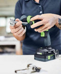 Heavy Duty Brushless Cordless Drill And Driver With Unbreakable Gears And 18 Volt Battery being held by a contractor.