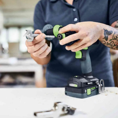 Heavy Duty Brushless Cordless Drill And Driver With Unbreakable Gears And 18 Volt Battery being held by a contractor.