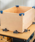 Clamp It Corner Woodworking Jig For 90 Degree Right Angle Cabinet Assembly Hands Free Pro Grade Panel Positioning And Precise Alignment In Woodworking Cabinets Casework And Carpentry Projects assembled on a wooden box for demonstration.