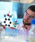 Scientist examining Hands On Molecular Model Kit for Students with 207 Pieces Including 79 Atoms in laboratory setting