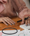 Universal Money Counting Machine Belt Replacement on desk near person using calculator, focus on belt.