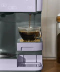 Total Game Changer Multi Brew Coffee Maker 12 Cup Glass Carafe Plus Single Serve Brewer For Pods Or Grounds Brews Over Ice No Fuss Touchscreen pouring fresh coffee into glass cup.