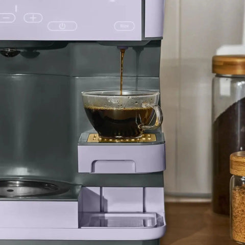 Total Game Changer Multi Brew Coffee Maker 12 Cup Glass Carafe Plus Single Serve Brewer For Pods Or Grounds Brews Over Ice No Fuss Touchscreen pouring fresh coffee into glass cup.