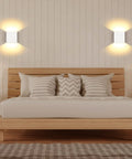 Bedroom with Cord Free Battery Powered Wall Sconce With Touch Dimmer, Rechargeable LED Wall Light In Black, emitting warm white glow