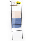 Versatile Blanket And Towel Ladder With Shelf Wall Leaning Black Iron Rack displaying towels and decor items.