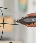 Dremel EZ-Lock rotary tool with a 1.5-inch cut-off wheel cutting metal rods; sparks visible.