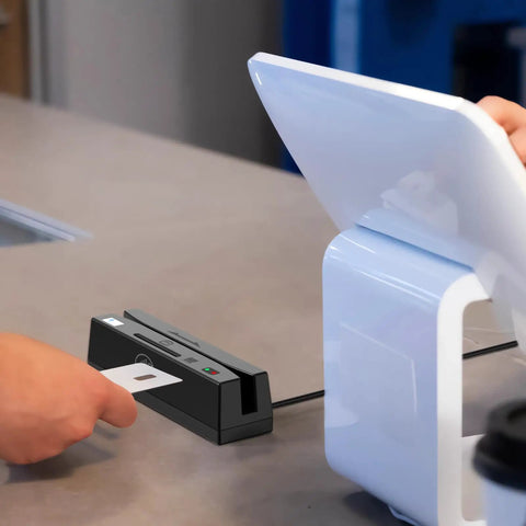 USB 4 In 1 Magnetic Card Reader And Writer With Contactless PSAM And Chip Card Support Read And Write APDU Commands Windows Compatible Plug And Play For Pros on a countertop processing a card.