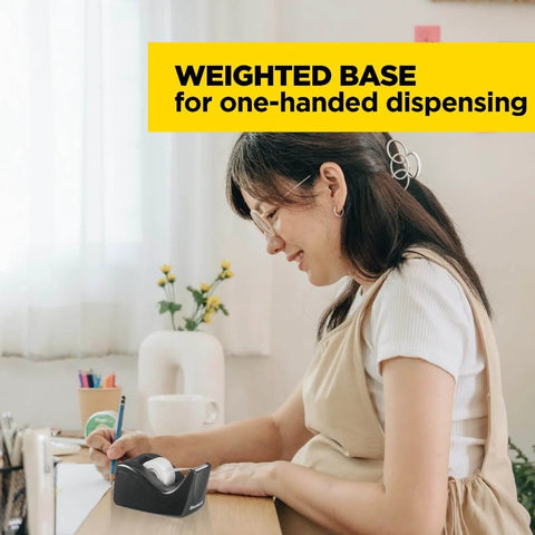 Woman using Deluxe Black Desktop Tape Dispenser With Weighted Non Skid Base For One Handed Dispensing Holds 1 Inch Core Tape on desk