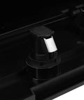 Close-up of black plastic marine glove box lock on boat console with silver latch.