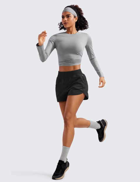 Woman running in black Dolphin Hem Athletic Shorts, 3 Inch Inseam, High Rise, Ultra Soft Lightweight Quick Dry Fabric, Built In Mesh Liner Reduces Friction, Zipper Pocket For Phone, No Swish Comfort, Comfy Dolphin Hem For Everyday Workouts Black