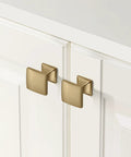 Champagne bronze cabinet pulls installed on white cabinets for modern kitchens, part of the 2 Pack 12 Inch Cabinet Handles set.