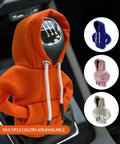 Gear Shift Hoodie Cover for Cars in orange, displayed on a car shifter with additional colors shown: blue, pink, white.