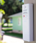 Wireless Outdoor Temperature and Humidity Sensor With Wall Mount Weather Resistant Gauge 330 Feet Transmission Range Battery Powered For Accurate Readings in Your No Fuss Home Weather Station installed on exterior wall.
