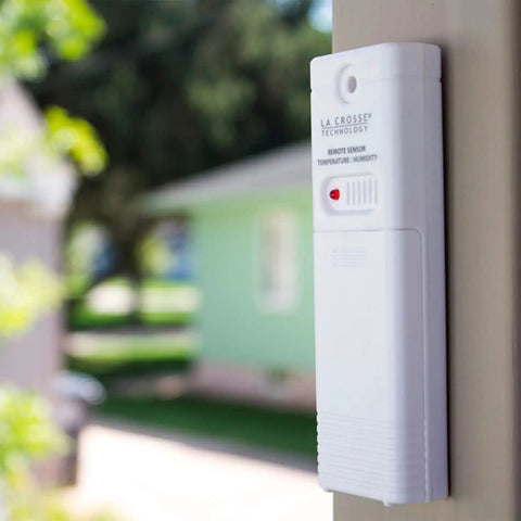 Wireless Outdoor Temperature and Humidity Sensor With Wall Mount Weather Resistant Gauge 330 Feet Transmission Range Battery Powered For Accurate Readings in Your No Fuss Home Weather Station installed on exterior wall.