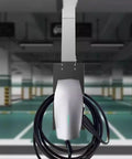 Tough As Nails Stainless Steel EV Charger Cover And Weatherproof Station Box with a charging cord in an indoor parking lot.