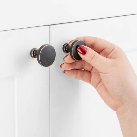 Hand installing Ten Pack One And One Quarter Inch Oil Rubbed Bronze Cabinet Knobs Brushed Bronze Round Drawer Pulls