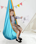 Child sitting in Ultra Comfy Kids Swing Seat Hammock Chair For Indoor Or Outdoor Use with soft nylon material and reinforced stitching.